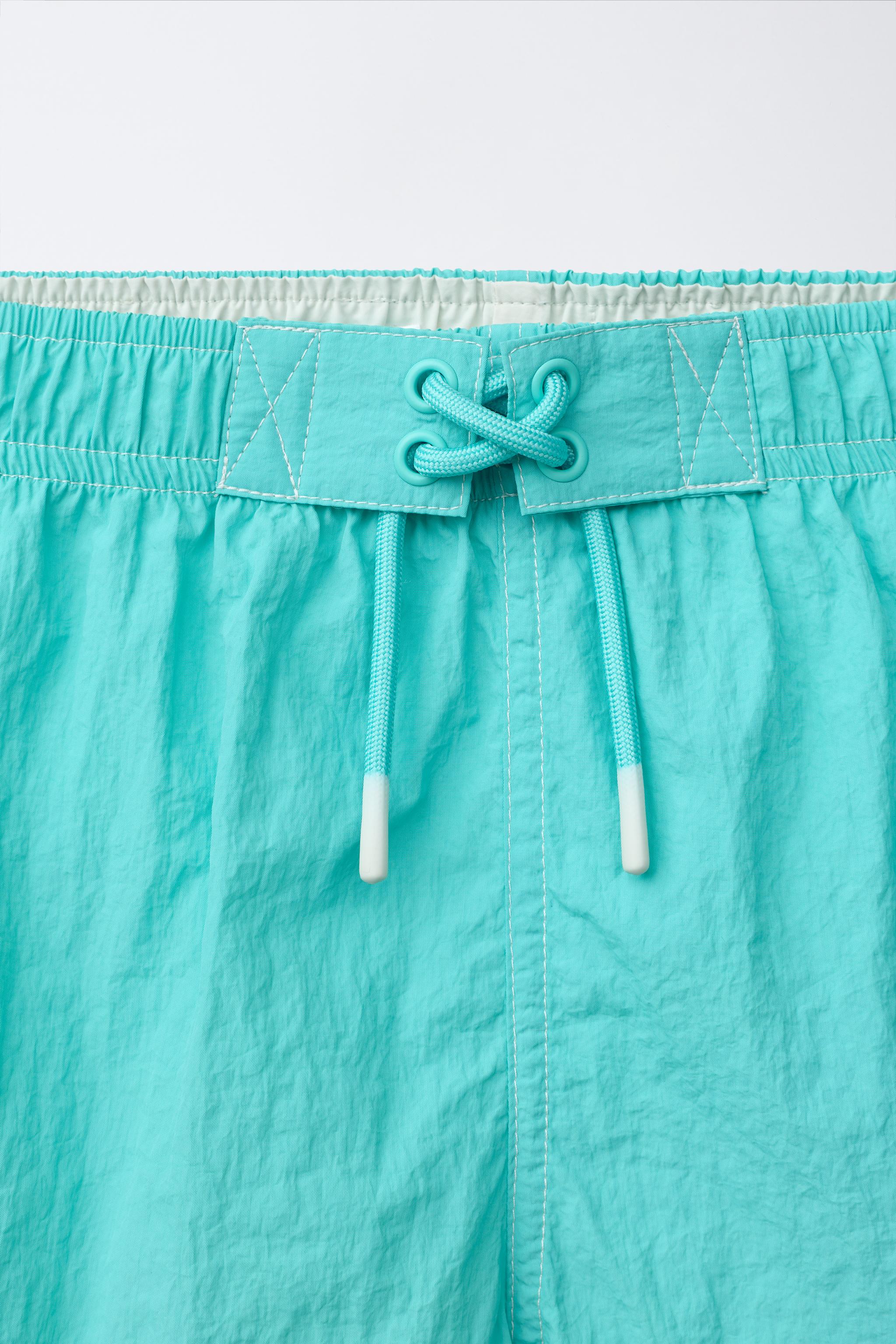 AGES 6-14 / SWIM SHORTS WITH DOUBLE CONTRAST HEM